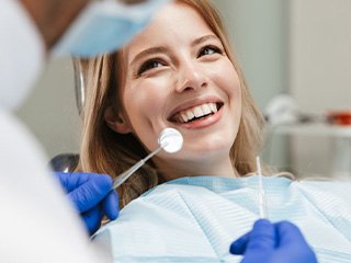 Lady smiles at dentist