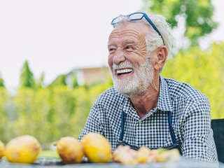 Man smiles at picnic table