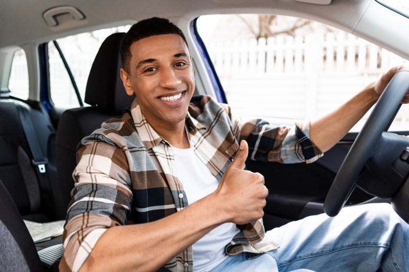 Guy smiles in car